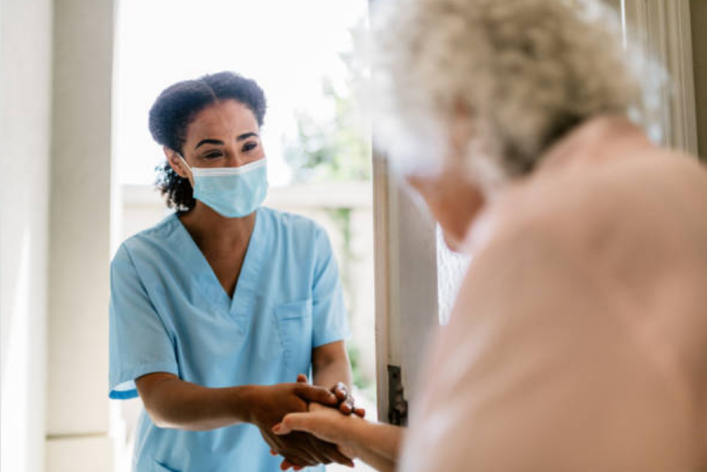 Photo of nurse visiting patient.